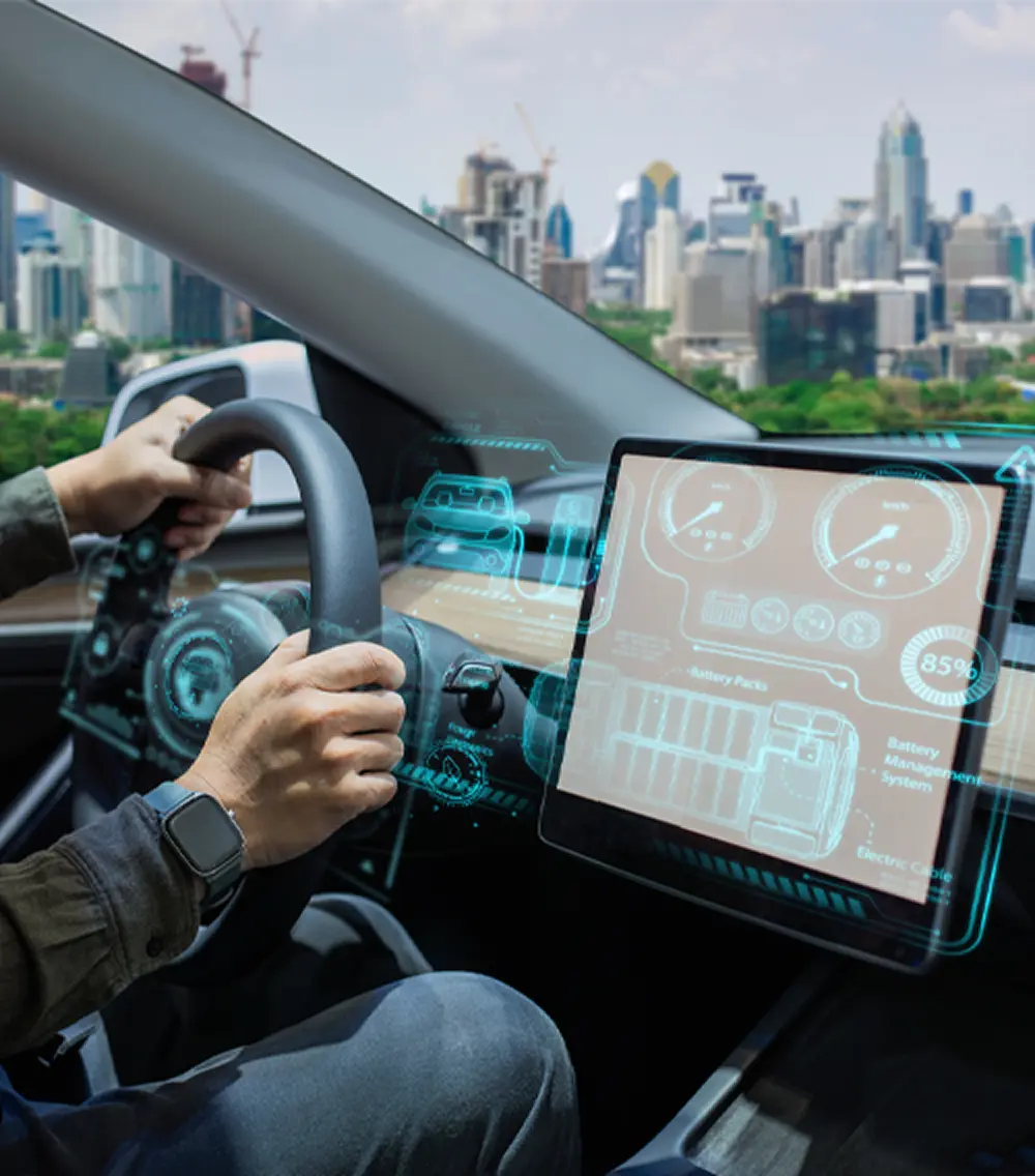 Closeup of car cockpit with hands on the wheel and the electronic HUD.