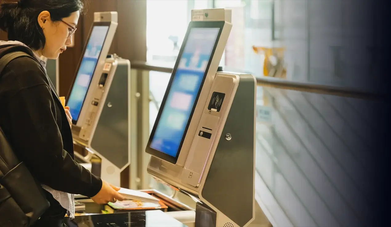 Woman scanning a document at a hands-free kiosk