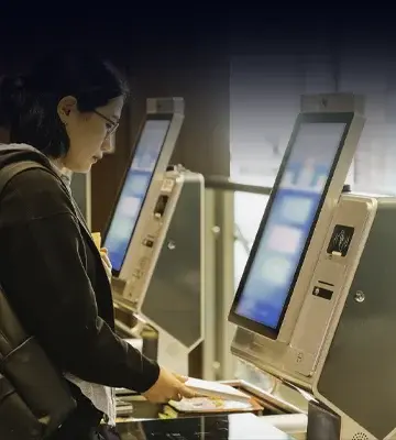 Woman scanning a document at a hands-free kiosk